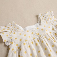 Imagen de Vestido de niña con estampado de lunares en tonos amarillos