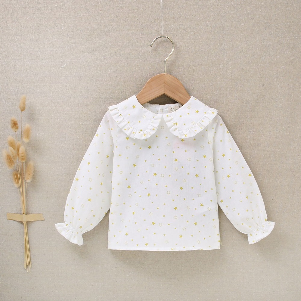 Imagen de Blusa de bebé niña blanca con estampado de estrellas amarillas