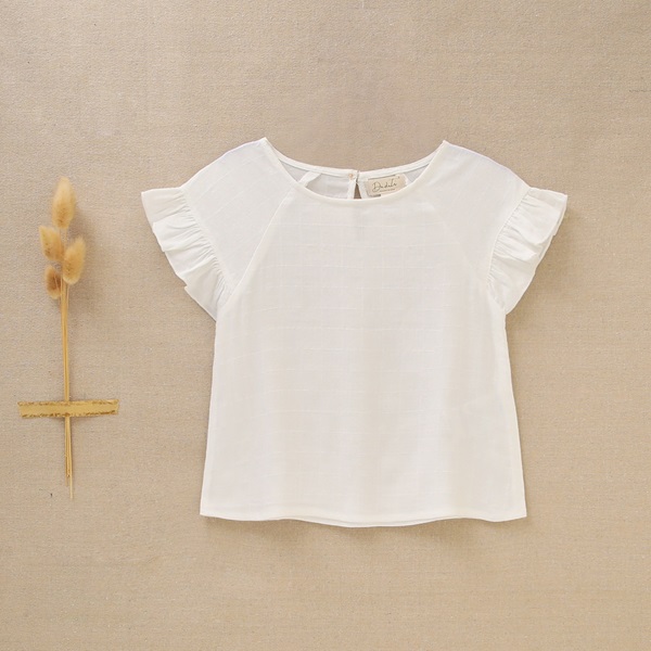 Imagen de Blusa de niña en blanco con mangas cortas y volantes