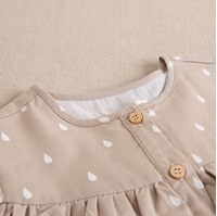 Imagen de Vestido niña beige con gotas de agua blancas