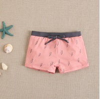 Imagen de Boxer de lycra para bebé niño en color coral con estampado de rayos grises