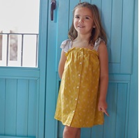 Imagen de Vestido de niña amarillo mostaza con estampado de soles