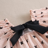 Imagen de Vestido de niña rosa palo con estrellas negras