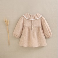 Imagen de Vestido de bebé niña beige tostado con estampado de estrellas blancas y cuello volante